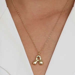 Minimalist 18k gold plated 3D bubble letter A pendant necklace on a fashion model