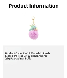 Detail view of unicorn plush keychain with 8cm purple faux fur ball and rainbow glitter horn