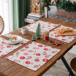 Christmas theme rectangle fabric placemat with red ball print on wooden table