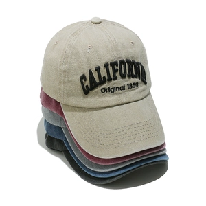 Detail of CALIFORNIA embroidery on vintage washed cotton baseball caps in multiple colors