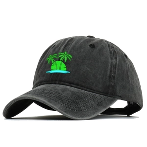 Close-up of tropical palm tree embroidery on black washed cotton baseball cap texture