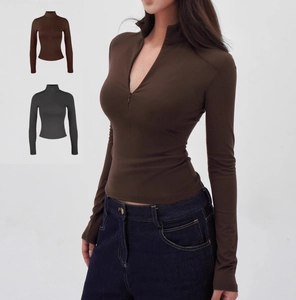 Detail of coffee brown V-neck half-zip long sleeve fitness top with fine knit texture
