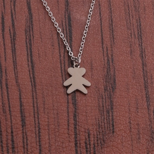 Polished stainless steel bear pendant necklace for men on a dark wood background