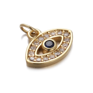 Macro detail of gold Evil Eye pendant with blue zircon stone and clear crystal inlay