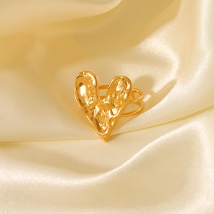 Detail of 18K gold plated heart ring on champagne silk showing hammered metal texture