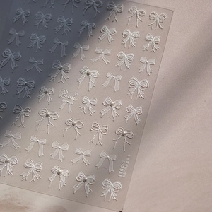 Embossed white bow nail stickers with pearls and vintage lace patterns on sheets