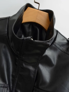 Detail view of the black faux leather jacket featuring a stand collar and metal zipper