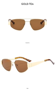 Detail view of retro pilot sunglasses with gold metal frame and brown lenses