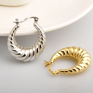 Pair of gold and silver hollow twisted hoop earrings with a high-polish metallic finish