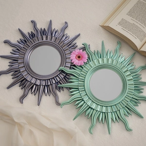 Artistic sunburst wall mirrors in purple and green resin for stylish home wall decor