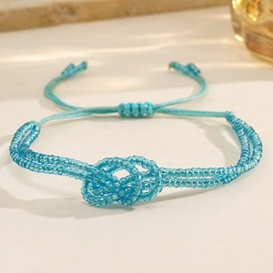 Bohemian light blue seed bead bracelet with adjustable woven cord and knot detail