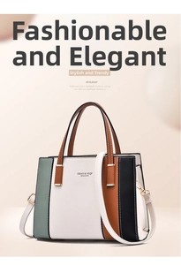 Detail of color-block tote bag with vertical stripes and golden metallic hardware