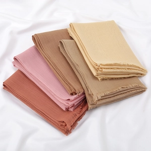 Folded breathable slub cotton scarves in beige and pink with soft tassel fringe details