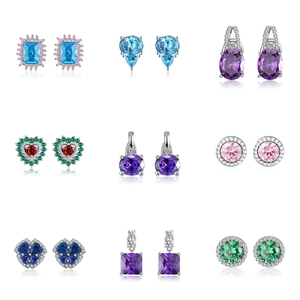 Macro shot of 925 silver earrings set with colorful cubic zirconia in geometric shapes