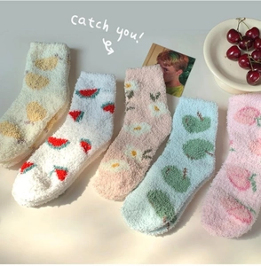 Detailed flat lay of 5 pairs of plush coral fleece socks with colorful fruit patterns