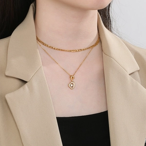 Elegant double-layered gold necklace with a musical note pendant and crystal inlay