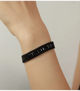 Close-up of elegant titanium steel bracelet featuring rectangular black zircon stones