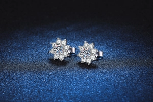 Macro shot of silver sunflower earrings featuring a brilliant 1 carat center moissanite