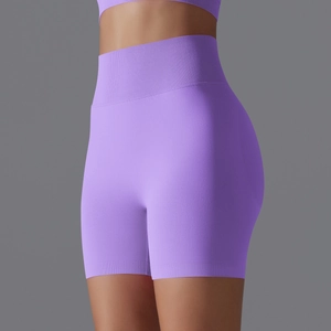 Close-up of seamless purple high-waisted fitness shorts with ribbed texture and compression band