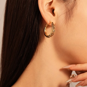 Chic gold-plated geometric hoop earrings with amber rhinestones on a female model
