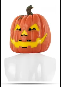Detail view of the back of a vibrant orange latex pumpkin mask with realistic skin texture