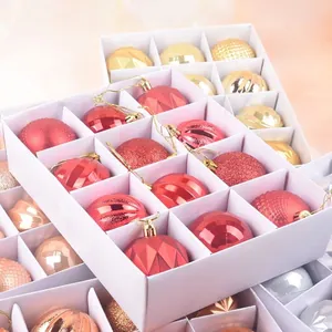 12-pack assorted Christmas tree ornaments with matte and glitter finishes in a display box