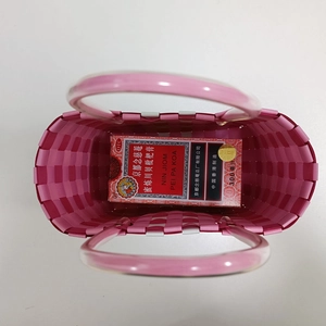 Top view of pink handmade woven bucket bag with transparent handles for summer storage