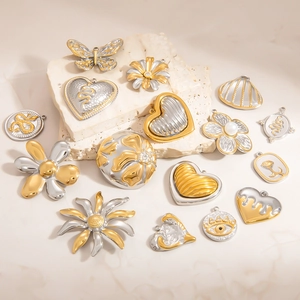18K gold plated stainless steel heart and butterfly pendants on white marble stones