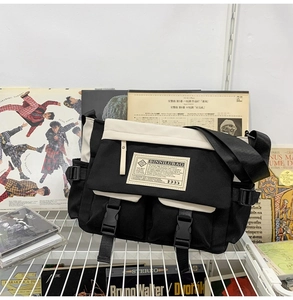 Detail of canvas messenger bag with functional buckle and vintage street style branding