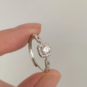 Macro view of sterling silver halo ring featuring a chain design and adjustable band