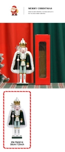 Detail of a 30cm wooden Nutcracker King in green cloak with its festive red gift box