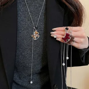 Lariat necklace with flocked rocking horse pendant and pearls in luxury style