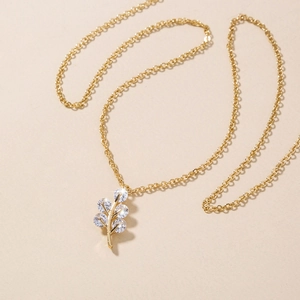 Elegant gold leaf pendant necklace with six white zircons on a delicate chain