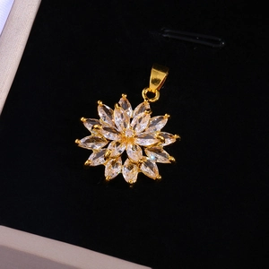 Golden sunflower pendant necklace with marquise-cut cubic zirconia on black velvet background