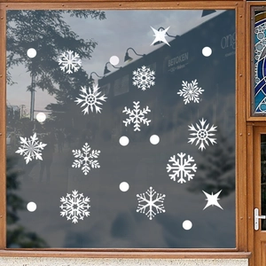 White snowflake window decals with various patterns on glass for Christmas decoration