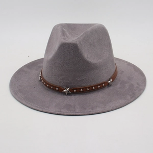 Close-up of gray fedora with brown leather band featuring silver stars and metal studs