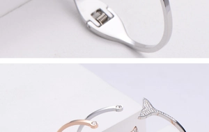 Detail of dolphin tail bangle showing crystal pavé and flexible spring hinge mechanism