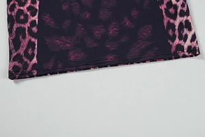 Detail of dress hem showing purple fabric stitched with pink leopard print and double seams