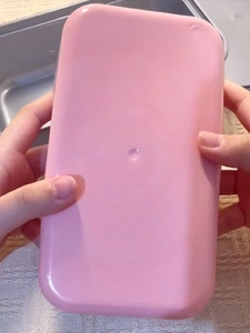 Pink rectangular plastic container for squishy cake toy showing a smooth back finish