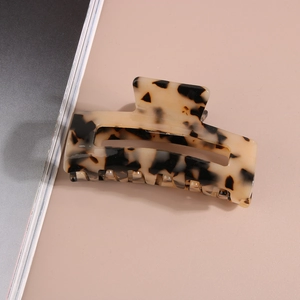 Close-up detail of tortoise shell cellulose acetate hair claw clip with 8.2cm rectangular design