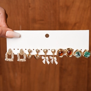 Detailed set of six resin and faux pearl earrings including bows and heart shapes