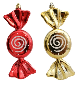 Close-up of red and gold Christmas candy ornaments with glitter spiral patterns