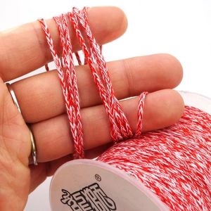 Red and white twisted cotton twine roll for DIY crafts and gift wrapping projects