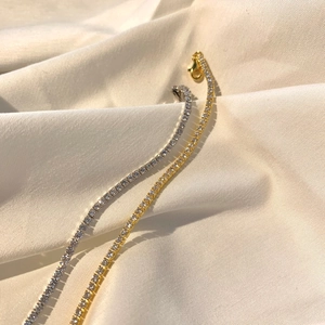 Detail view of gold and silver S925 sterling silver tennis bracelets with zircon stones