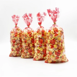 Detailed view of clear heart pattern treat bags with gold twist ties for candy