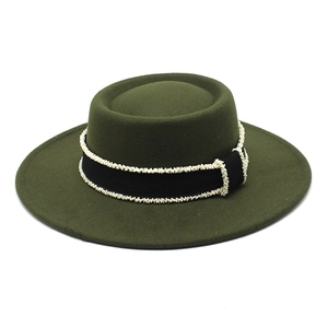 Detail of dark green flat top felt hat with elegant pearl-beaded black ribbon trim