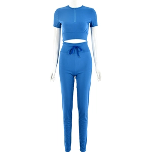 Blue ribbed knit two-piece set featuring half-zip crop top and high-waisted drawstring pants