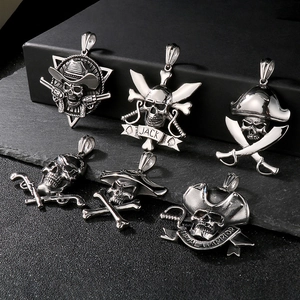 Macro shot of silver stainless steel pirate skull pendants in punk rock naval warrior style
