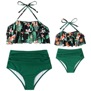 Matching mother daughter two-piece swimsuits with tropical leaf prints and high waist bottoms