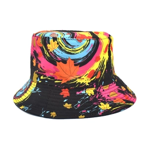 Colorful reversible bucket hat with maple leaf print and street style graffiti pattern